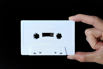 Mockup white Compact Audio Cassette holding hand. White tape.