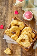 Valentine's Day, Birthday or Mother's Day, breakfast, holiday food. Homemade curd cheese cookies with hearts on a wooden rustic table. Top view flat lay.