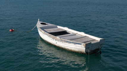 A lonely white boat in the bay