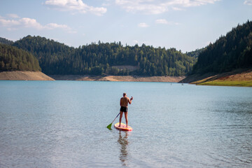 Active senior paddles a kayak at Zaovine Lake
