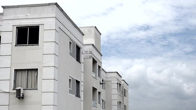 Time lapse clouds crossing the residential building.