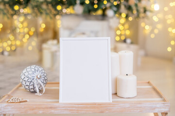 Christmas photo frame mock up template with decoration on wooden table.