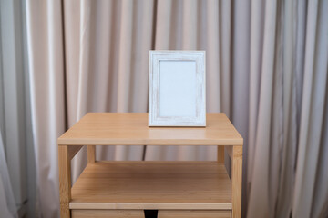 Portrait picture frame mockup on wooden table. Scandinavian minimalism