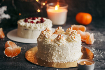 Christmas cakes. Delicious cakes with winter decor. Cakes with lingonberries and tangerines on the table