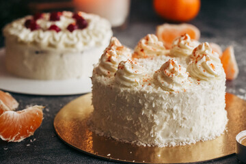 Christmas cakes. Delicious cakes with winter decor. Cakes with lingonberries and tangerines on the table