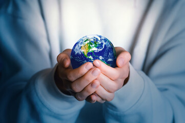 Human holds Earth planet globe. Our home. Green planet. Environmental protection concept.