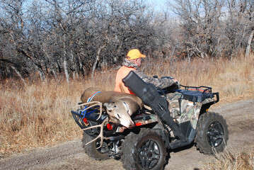 Hunter with a trophy mule deer on a quad