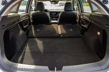 Huge, clean and empty car trunk in interior of compact suv. Rear view of a SUV car with open trunk