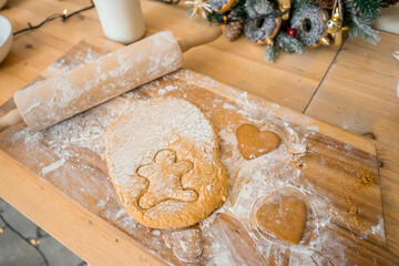 Cooking gingerbread cookies. Rolling pin, dough, flour and other ingredients on a black background. Flat lay style
