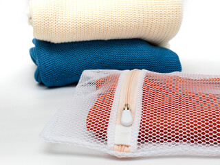 Knitwear in a bag for delicate washing of fabrics. The concept of gentle washing of clothes, fabrics © Наталья Устинова