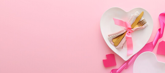 Beautiful table setting for Valentine's Day on pink background with space for text
