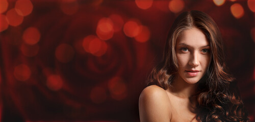 Beautiful young woman on dark red background with space for text