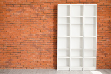 Empty shelf unit near brick wall in room