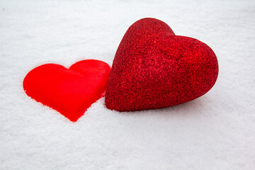 Two figurines of hearts in the snow