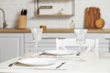 Dining table with empty glasses in kitchen