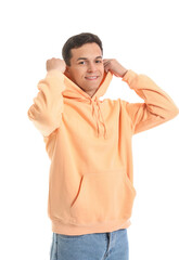 Young man in orange hoodie on white background