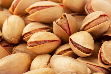 Salted pistachios as a background closeup, top view, flat lay	