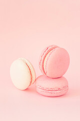 Colorful macaroons on pastel pink peach background, concept romantic sweet dessert