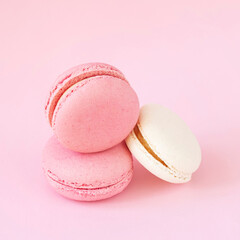 Three macaroons close-up lying on pink background