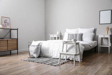 Interior of light bedroom with white step stool