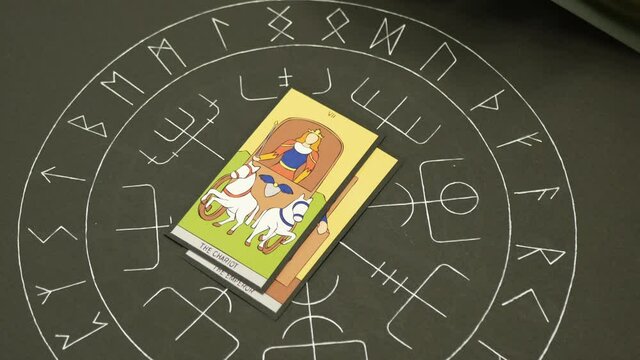 Adult woman puts tarot cards on table. Hands of fortune teller woman puts different cards on table with altar of tarot. Forecasting concept.