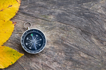 Compass on old wooden background. Copy space