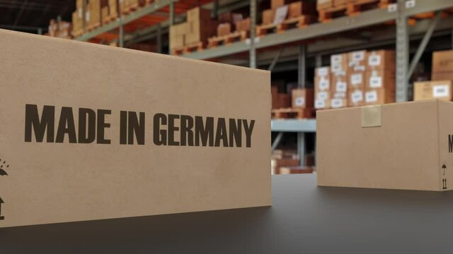 Boxes with MADE IN GERMANY text on conveyor. American goods related loopable 3D animation