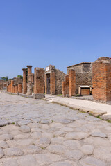 Ruins of an ancient city destroyed by the eruption of the volcano Vesuvius near Naples, Pompeii, Italy. View of one of the city streets - obrazy, fototapety, plakaty