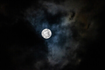 Naklejka na ściany i meble Full moon in the night sky among the clouds
