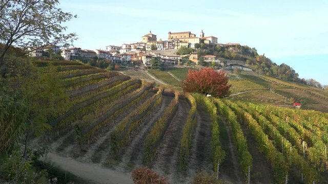 Beautiful hills and vineyards during fall season surrounding La Morra village. In the Langhe region, Cuneo, Piedmont, Italy.