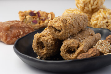 Indian traditional sweets for Makar Sankranti Or Lohri Mithai Gajak Also Known As Gur Gajjak, Gazak, Gachak Til Patti Or Papdi, Chikki Is Made Of Jaggery Gud, Almonds Badam And Pistachio