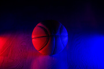 Basketball ball isolated on dark background. Blue neon banner. Horizontal sport theme poster,...