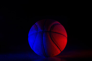 Basketball ball isolated on dark background. Blue neon banner. Horizontal sport theme poster,...