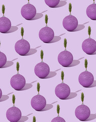 Creative pattern concept. Christmas and New Year decoration. Pastel purple background. Minimal festive composition of violet baubles and green twig. Chinese New Year.