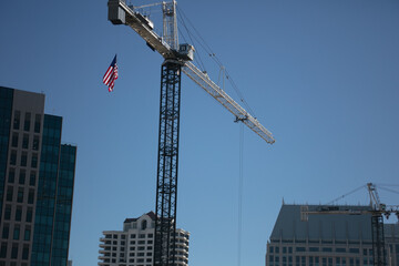 A Building Under Construction with a Tall Crane Lifting Material to the Structure