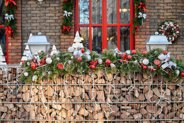 Fototapeta na wymiar Seasonal Christmas decoration at front of a building at european city street. Festive street decor in winter holidays. Selective focus.