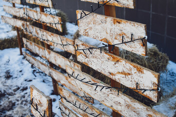 Close up of a creative Christmas tree made of rustic wooden planks. Selective focus.