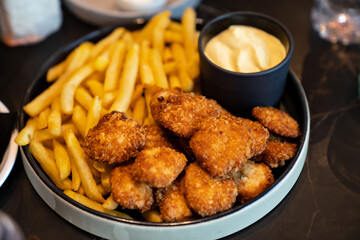 nuggets with french fries in a bowl. fast food. delicious and harmful fried food