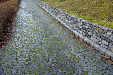beautifully folded retaining wall with a granite attic with small joints. brown beige yellow...