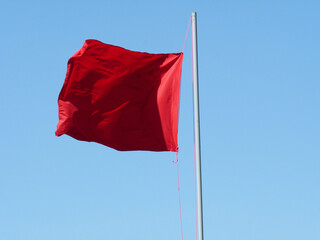 red flag against blue sky