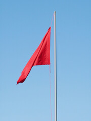 red flag against blue sky