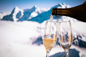 champagne glasses  and snowy peaks in background  New Year