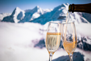 champagne glasses  and snowy peaks in background  New Year