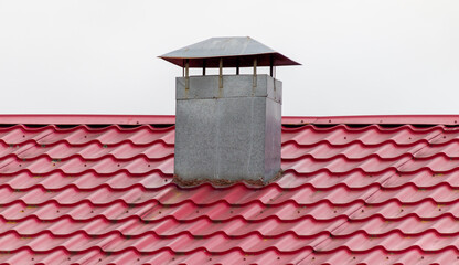 chimney on the roof made of red metal tiles