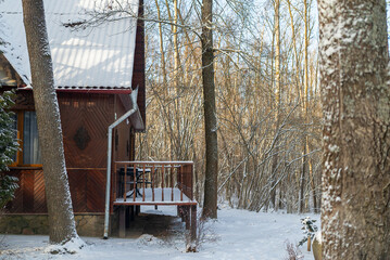 wooden porch snow-covered wooden house in winter forest