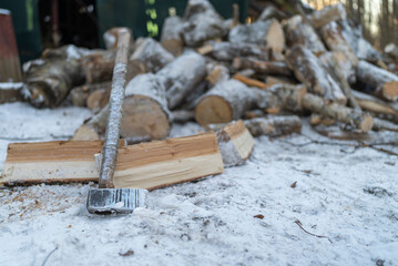 an old axe to lie on split wooden firewood