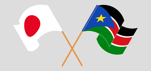 Crossed and waving flags of Japan and South Sudan