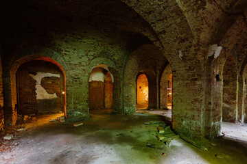 Vaulted red brick dungeon under old mansion