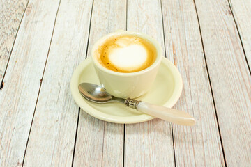 Obraz premium Barista coffee with cream and vintage spoon