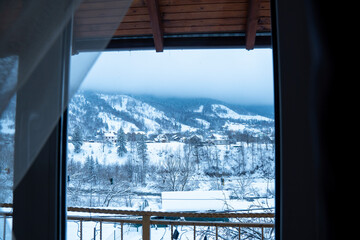 Snowy background behind the window in winter mountains